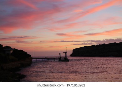 Beautiful Ocean Sunset, Cloudy Beach Horizon With Fishing Wharf Silhouette, Orange Sky Background