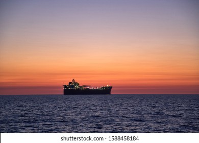 Beautiful  Ocean Sunset, With Colorful Clouds, Blue Ocean And Silhouette Of Ship, Oil Tanker On The Horizon.