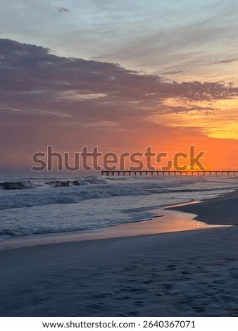 Beautiful ocean sunset, with peer and sand
