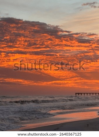 Beautiful ocean sunset, with peer and sand