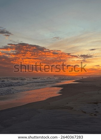 Beautiful ocean sunset, with peer and sand