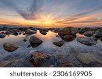 A Beautiful Ocean Sunset With Sea Rocks Sitting In A Tide Pool High Resolution