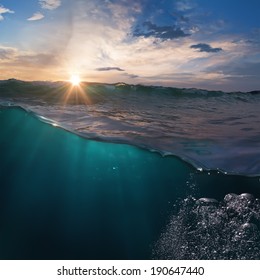 Beautiful Ocean View With Sunset Behind Breaking Surfing Wave Over Deep Blue Water For You Design