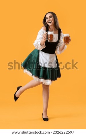 Beautiful Octoberfest waitress with beer dancing on yellow background Foto stock © 
