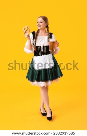 Beautiful Octoberfest waitress with beer and pretzel on yellow background Foto stock © 