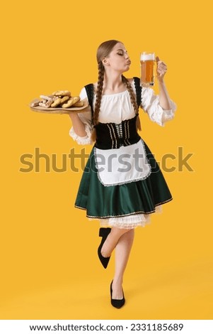 Beautiful Octoberfest waitress with beer and snacks on yellow background Foto stock © 