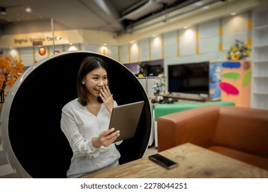 Beautiful office lady was surprised about her sales this month while sitting on a modern round chair in the living room. - Powered by Shutterstock