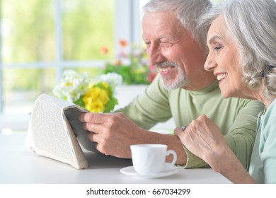 Beautiful Old Couple Reading A Newspaper