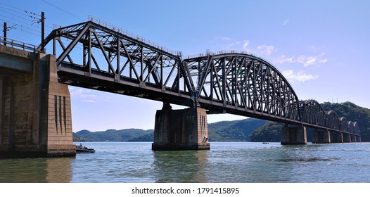 Beautiful Old Iron railway bridge over the sparkling waters of the Hawkesbury River in the NSW central coast region - Powered by Shutterstock
