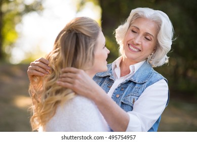 Beautiful Old Lady Playing With Hair Of Her Daughter