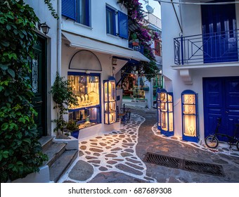 Beautiful old, narrow alley with cobblestone in Skiathos, Greece - Powered by Shutterstock