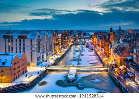 Beautiful old town in Gdansk over Motlawa river at winter dusk, Poland