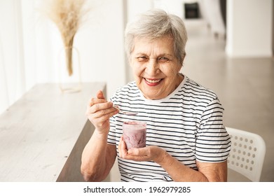 Beautiful Old Woman Eating Yogurt.