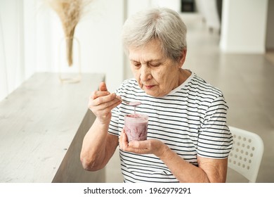 Beautiful Old Woman Eating Yogurt.