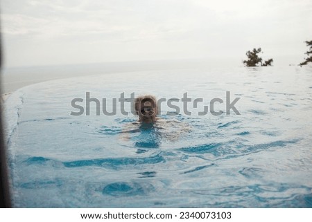 Similar – Rückansicht einer blonden Frau  im Infinity Pool