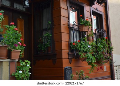 Beautiful Old Wooden House Window With Red Sardinia Flowers, Home Entrance With Flowers, No People, Kuzguncuk, Old Istanbul House View, Istanbul, August 2012.