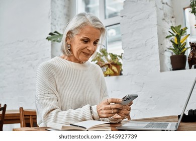 A beautiful older woman interacts with her smartphone while sitting comfortably indoors. - Powered by Shutterstock