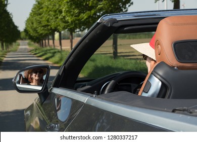 Beautiful Older Woman In A Luxury Convertible Car
