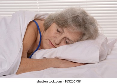 Beautiful Older Woman Sleeping In The Bedroom After A Hard Working Week