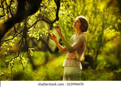 Beautiful Older Woman In The Summer Garden