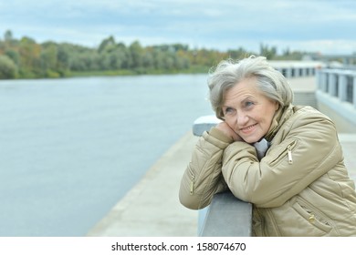 Beautiful Older Woman Walking In The Park Alone