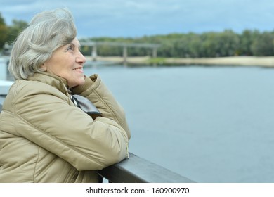 Beautiful Older Woman Walking In The Park Alone