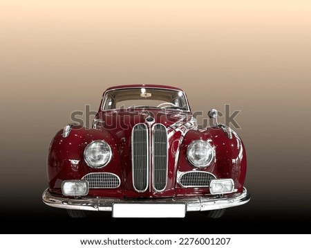 A beautiful oldtimer german vintage car in a bordeaux-red color