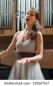 Beautiful opera singer sings in the concert hall