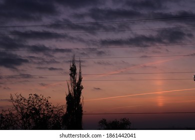 Beautiful Orange Sunset. Moody Dark Clouds In Autumn Sky. Tree Sillhouette.