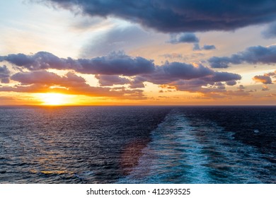 A Beautiful Orange Sunset At Sea In Wake Of Ship