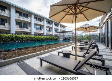 Beautiful Outdoor Swimming Pool With Umbrellas And Chairs, No People.