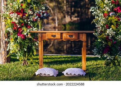 Beautiful Outdoor Wedding Altar Surrounded By Beautiful And Vibrant Green Decor