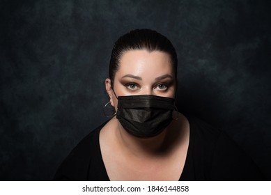 Beautiful Overweight Woman In Black Medical Mask On Black Background