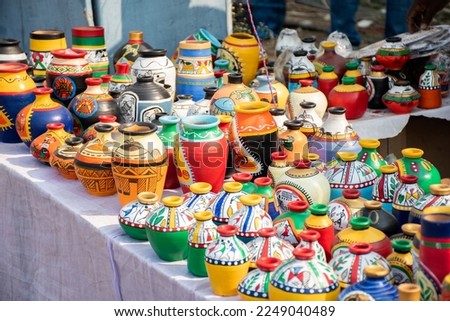 Beautiful painted clay pots, works of handicraft, for sale during Handicraft Fair in Kolkata. Selective focus.