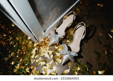 A beautiful pair of high heels is elegantly sitting on the floor, surrounded by a shimmering blanket of gold confetti that sparkles delightfully - Powered by Shutterstock