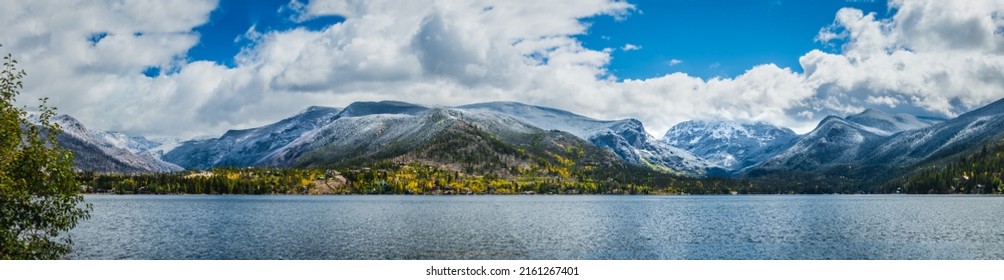 Beautiful Panorama Of Colorado Mountain Range By The Lake In Autumn; Mountains Covered With Snow; Small Town At The Base Of The Mountains