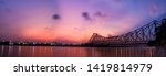 Beautiful panorama of Kolkata city with  Howrah bridge on the river Hooghly or  River Ganges during sunset