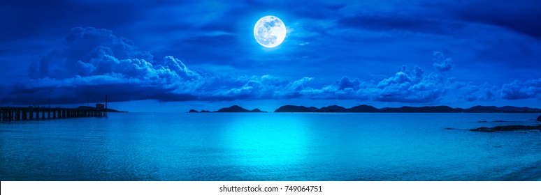 Beautiful panorama view of the sea. Colorful blue sky with cloud and bright full moon on seascape to night. Serenity nature background, outdoor at nighttime. The moon taken with my own camera. - Powered by Shutterstock