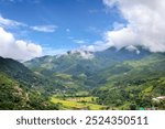 Beautiful Panorama views of the mountains and rice fields in the valley in during the rainy season at Sapun, Bo Kluea, Nan, Thailand.