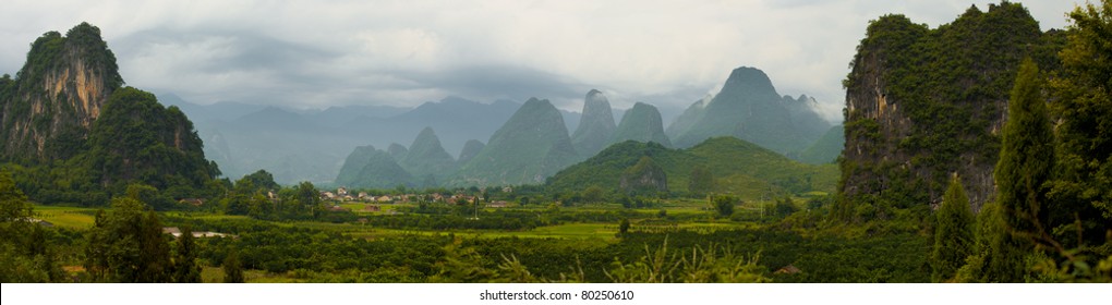 A beautiful panorama of the Xingping countryside surrounded by karst formation mountains typical of nearby Yangshuo and Guilin, China. Horizontal copy space