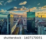 Beautiful panoramic aerial drone view to the Center of modern Warsaw city with silhouettes of skyscrapers in in the rays of the setting winter January sun - amazing sunset, Poland