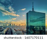 Beautiful panoramic aerial drone view to the Center of modern Warsaw city with silhouettes of skyscrapers in in the rays of the setting winter January sun - amazing sunset, Poland