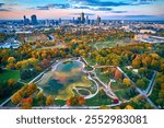 A beautiful panoramic aerial drone view of the sunset at Pola Mokotowskie in Warsaw, Poland - "Mokotow Field" is a large park in Warsaw - Is called "Jozef Pilsudski Park" or "Warsaw Central Park", EU