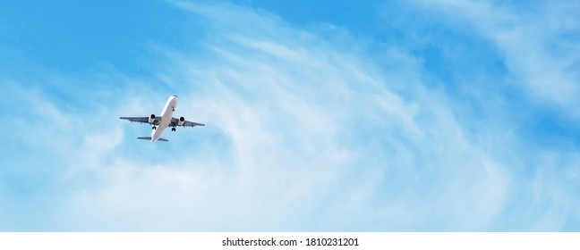 Beautiful Panoramic Background and flying plane in blue sky  Passenger airplane and landing gear released takes off in sky  Travel concept  Wide Angle Wallpaper Web banner With Copy Space