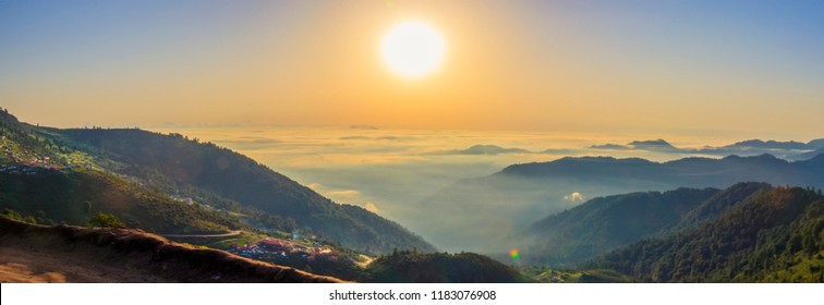 Beautiful panoramic landscape above clouds and mountains with sun rising in the middle. - Shutterstock ID 1183076908