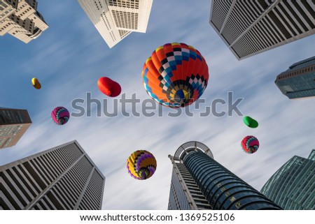 Beautiful panoramic urban cityscape in modern metropolis with colorful high hot air balloons festival in summer sky. Vacation travel panorama city background.