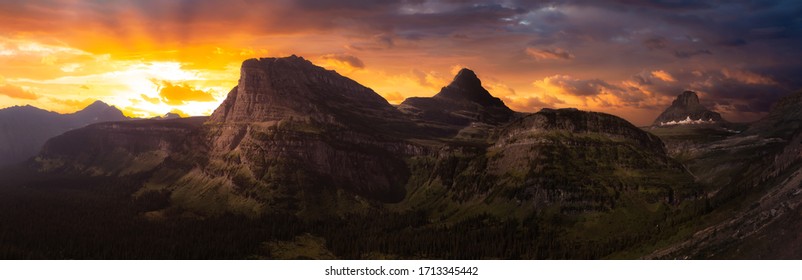 Beautiful Panoramic View of American Rocky Mountains during Cloudy Summer Sunset or Sunrise. Dramatic Sky Composite. Landscape: Glacier National Park, Montana, United States.