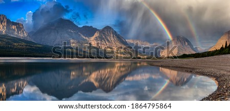 Beautiful Panoramic View of American Rocky Mountain Landscape. Dramatic Sunrise Sky with Rainbow. Art Render. Taken in Glacier National Park, Montana, United States.