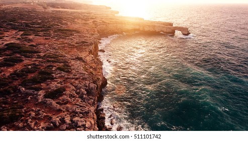 Beautiful panoramic view of cliffs at seashore. Sunset