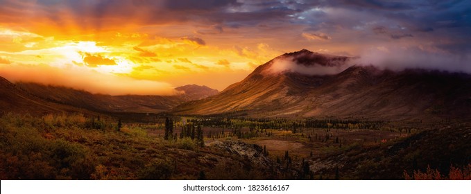 Beautiful Panoramic View Of Colourful Fall Forest And Mountains In Tombstone. Sunset Or Sunrise Sky Composite. Tombstone Territorial Park, Yukon, Canada. Nature Background Panorama